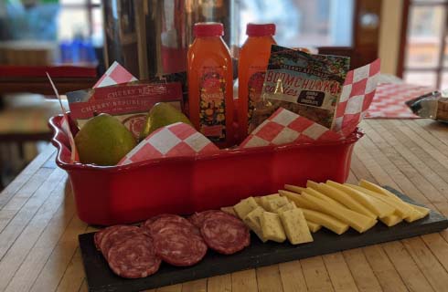 Plane Jane Basket with local cheeses, meats, and cookies.