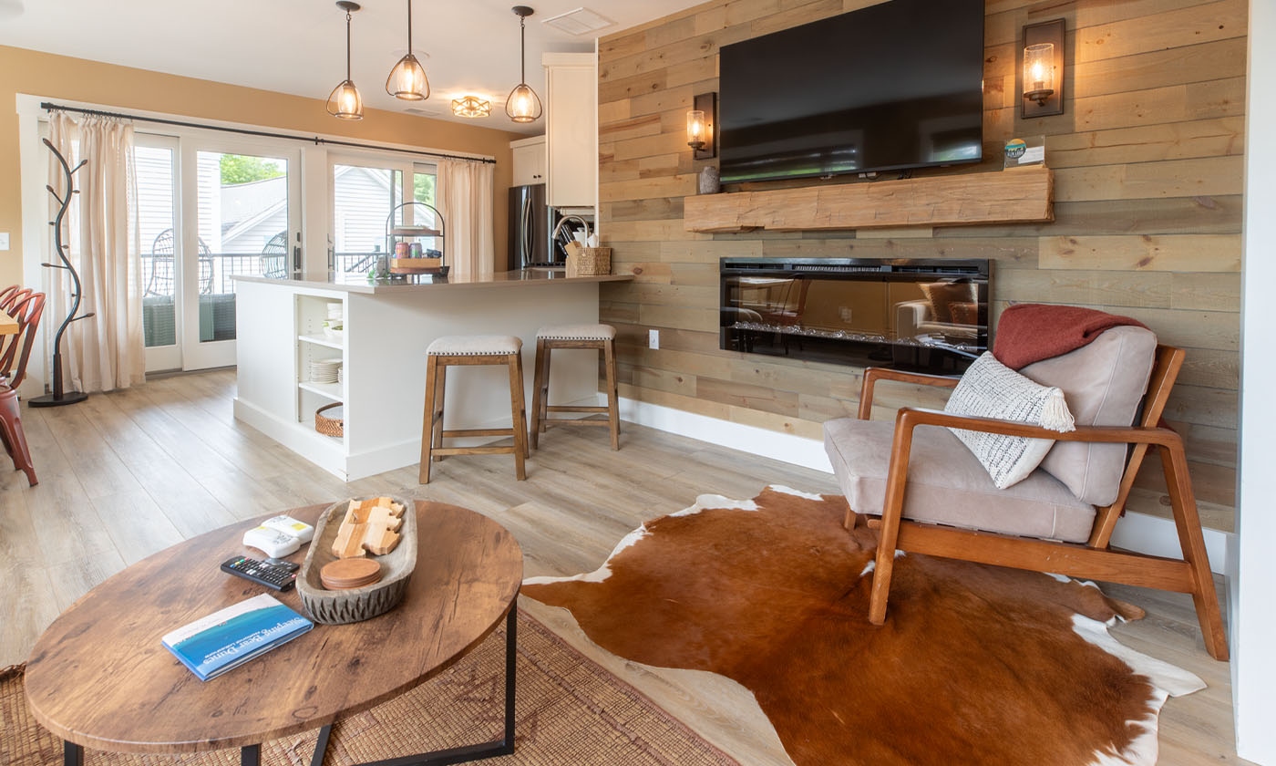 Glen Arbor condo near Sleeping Bear Dunes with open kitchen, breakfast bar, fireplace, and porch access.